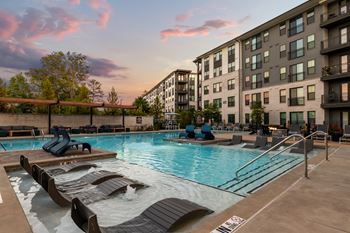 Resort-style saltwater swimming pool with tanning ledges and sundeck